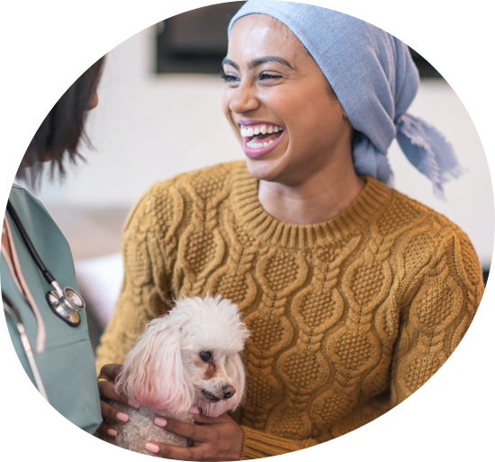 Young smiling black woman holding a small white dog