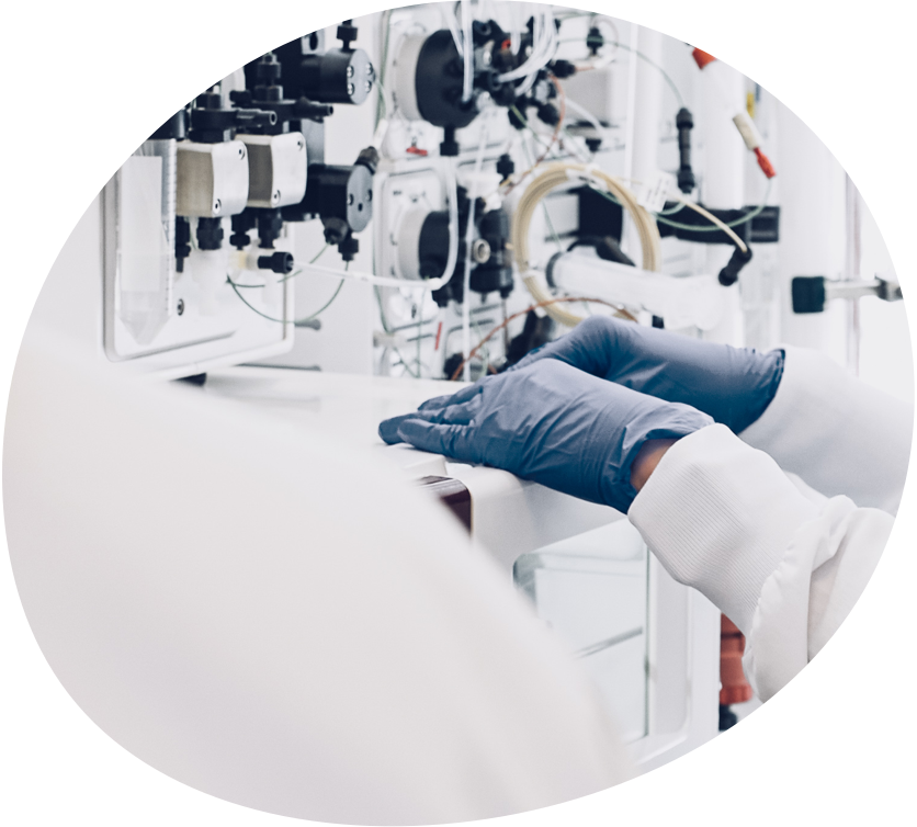 Close up of lab worker's gloved hands using equipment