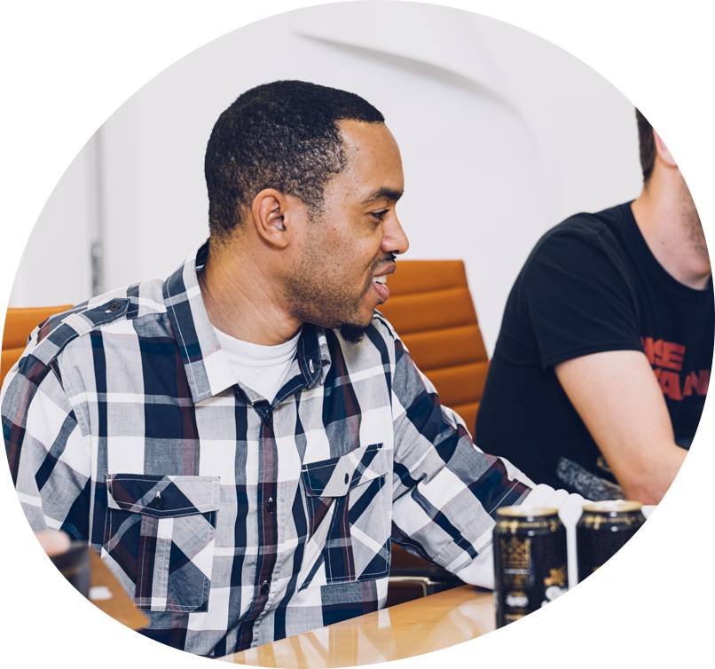 Smiling black man sitting at conference table